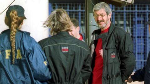 Leonardo Bertulazzi (R), an alleged former chief of the Italian militant group Red Brigade, is escorted by Argentine police after his arrest 4 November, 2002 in Buenos Aires)