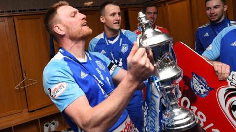 Rory McAllister celebrates the League 1 trophy with Peterhead