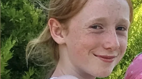 A picture of Ruth Szymankiewicz, a teenage girl who is smiling at the camera and has shoulder-length ginger hair.