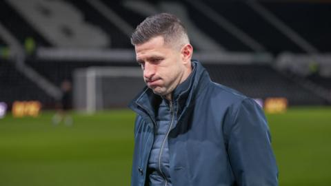 John Mousinho, head coach of Portsmouth, looking dejected during the match between Derby County and Portsmouth