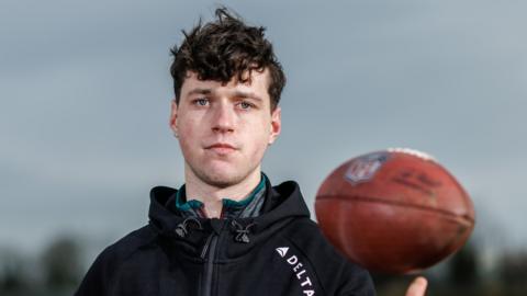 Charlie Smyth pictured with an American football