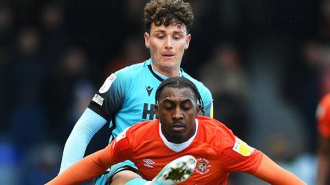 Amari'i Bell of Luton Town in action with Danny McNamara of Millwall