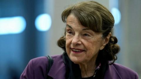 Dianne Feinstein smiles as she walks through the Senate subway in 2022