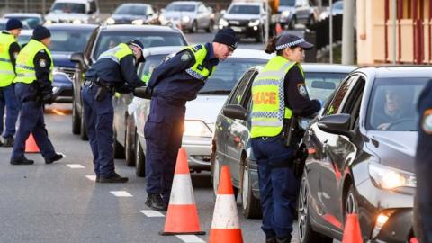 Police in the New South Wales (NSW) border city of Albury check cars crossing the state border from Victoria on July 8, 2020