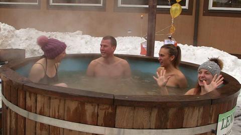 Christa Larwood (L) and other teammates in a hot tub taking part in the European Sauna Marathon