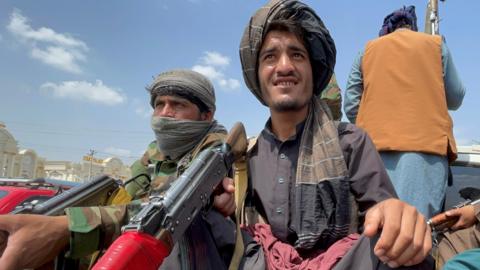 Taliban forces patrol near the entrance gate of Hamid Karzai International Airport, in Kabul, Afghanistan, 31 August 2021