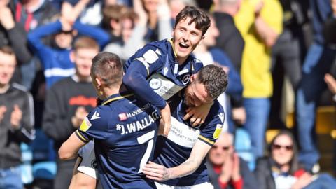 Danny McNamara celebrates with fellow Millwall players