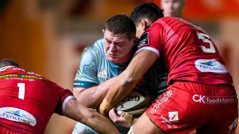 Leinster's Tadhg Furlong comes up against Phil Price and Sam Lousi of Scarlets