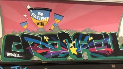 Grenfell written in graffiti in Oxford Circus Tube station