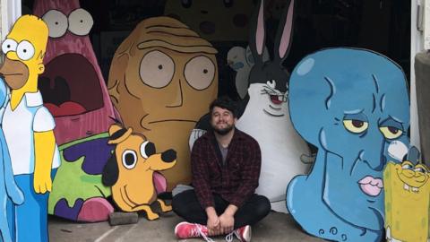 Mike Bennett surrounded by some of his artistic creations