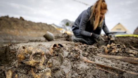 Archaeologists work at a mass grave on the city moat in Vianen, on November 24, 2020