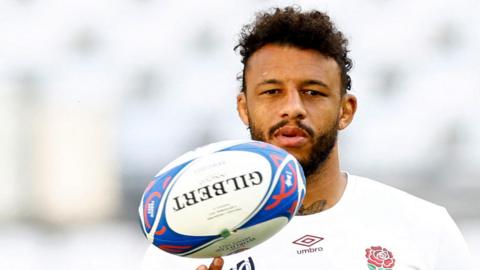 Courtney Lawes balancing a rugby ball on his finger