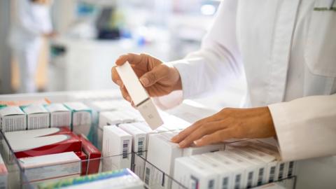 A pharmacist sorting through medicines