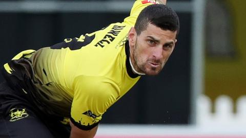 Benny Howell bowls for Gloucestershire