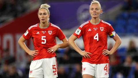 Rhiannon Roberts and Sophie Ingle wear white shorts while playing for Wales