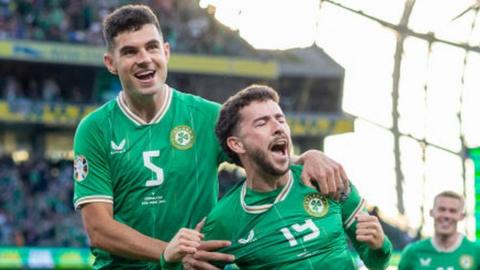 Mikey Johnston celebrates with John Egan