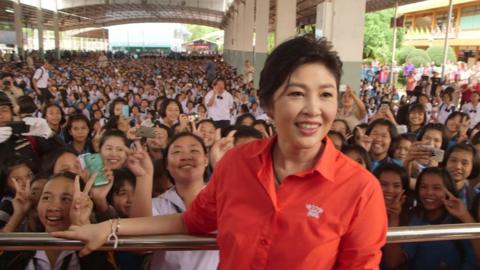 Former Thai Prime Minister Yingluck Shinawatra appears at a school