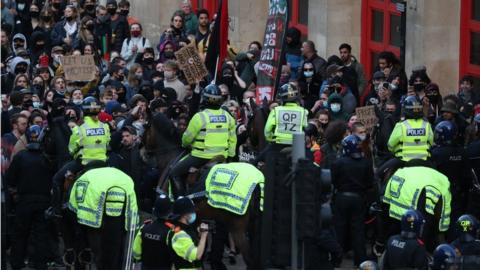 Police horses hold back protesters outside Bridewell Police Station as they take part in a "Kill the Bill" protest in Bristol