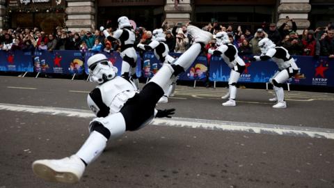 A performer dressed as a Stormtrooper break-dances