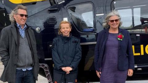 Martin Hughes, Amy Rowlands and Linda Hughes outside a police helicopter