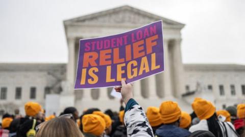 Activists and students protest in front of the Supreme Court during a rally for student debt cancellation