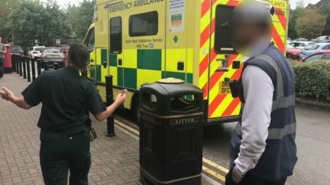 Parking attendant and paramedic arguing