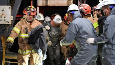 Two miners are pulled to safety after the collapse of a mine in South Korea