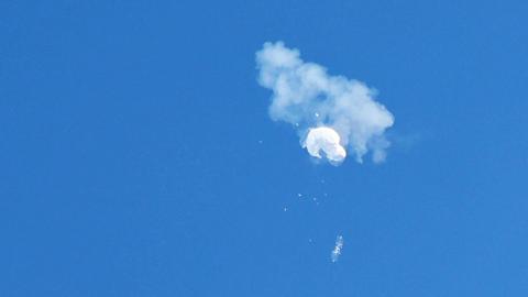 The suspected Chinese spy balloon drifts to the ocean after being shot down off the coast in Surfside Beach, South Carolina