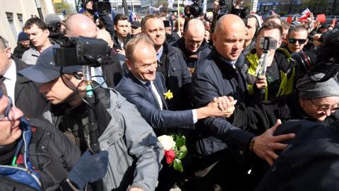 Former Polish Prime Minister, European Council President Donald Tusk (C) greets supporters on his way for questioning to the prosecutor's office in Warsaw, Poland, 19 April 2017