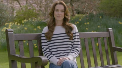 The Princess of Wales sits on a bench