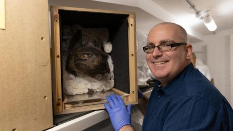 Dr Ken Griffin with some of the artefacts in a box