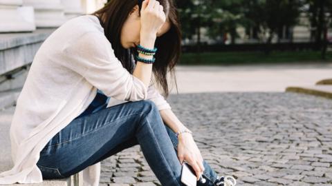 Anonymous woman holding phone