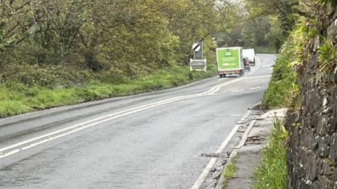 Vehicles on the A390 near the site of a fatal crash