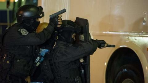 Members of various Brazilian police forces train during a hostage taking drill at the Central Bus station in Rio de Janeiro on early 1 October 2015.