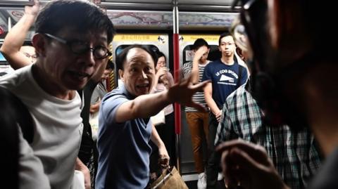 Angry commuters scuffle with HK protesters