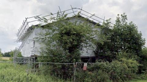 cottage under scaffolding