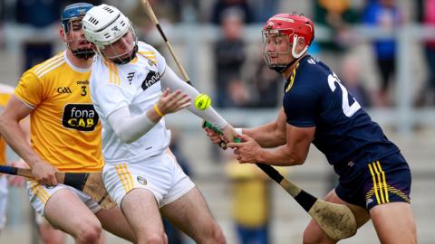 Antrim goalkeeper Ryan Elliott battles with Wexford's Lee Chin during the 2021 Allianz Hurling League game at Corrigan Park