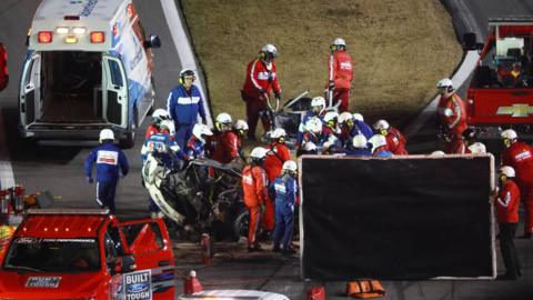 Emergency services tend to Ryan Newman's car after the driver crashed at the Daytona 500