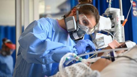 Staff care for a patient in critical care at Royal Papworth hospital in Cambridge