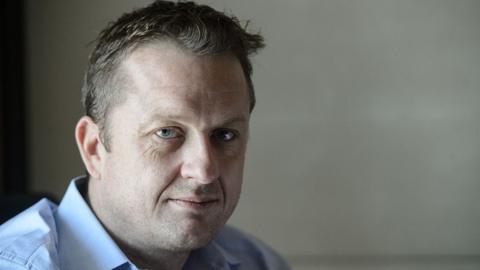 Journalist Andrew MacGregor Marshall poses during an interview with AFP at a hotel room in Hong Kong on 22 July 2016