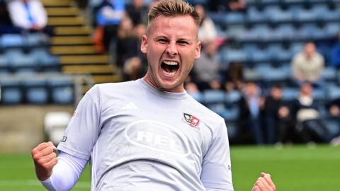 James Scott celebrates his goal for Exeter City at Wycombe