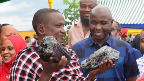 Saniniu Laizer, owner of a Tanzanian mining company, with a large Tanzanite gemstone in each hand