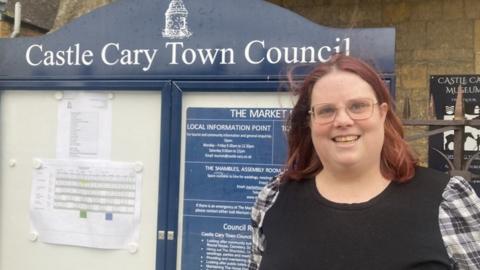 Katie Armstrong by the Castle Cary Town Council notice board