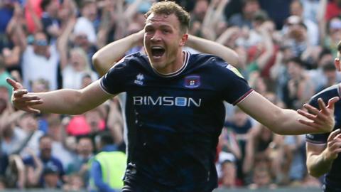 Ben Barclay celebrates the goal against Bradford City that secured Carlisle United's place in the 2023 League Two play-off final