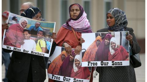 Outside a Minnesota courtroom, family members of the men on trial have gathered