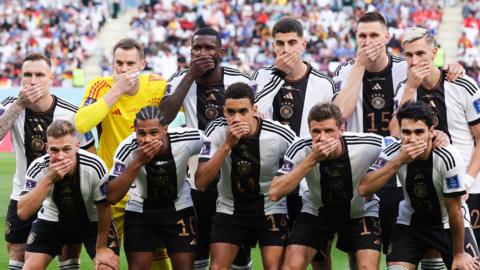 Germany team with hands over mouths