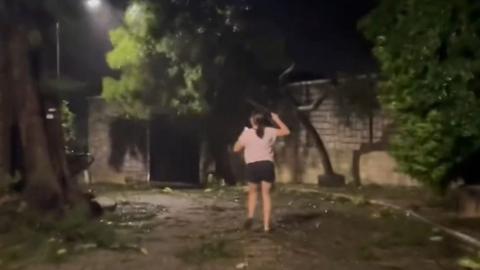 Woman running during Typhoon Saolo