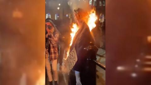 Protesters burn an effigy in Central London