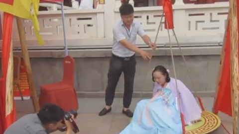 A woman sitting in a weighing scale