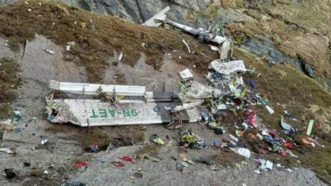 The wreckage of a Twin Otter aircraft, operated by Nepali carrier Tara Air, lay on a mountainside in Mustang on May 30, 2022, a day after it crashed.